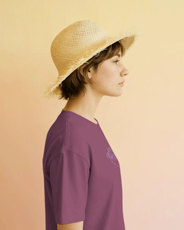 Guru Daddy Red Voilet tee - female side profile with straw hat